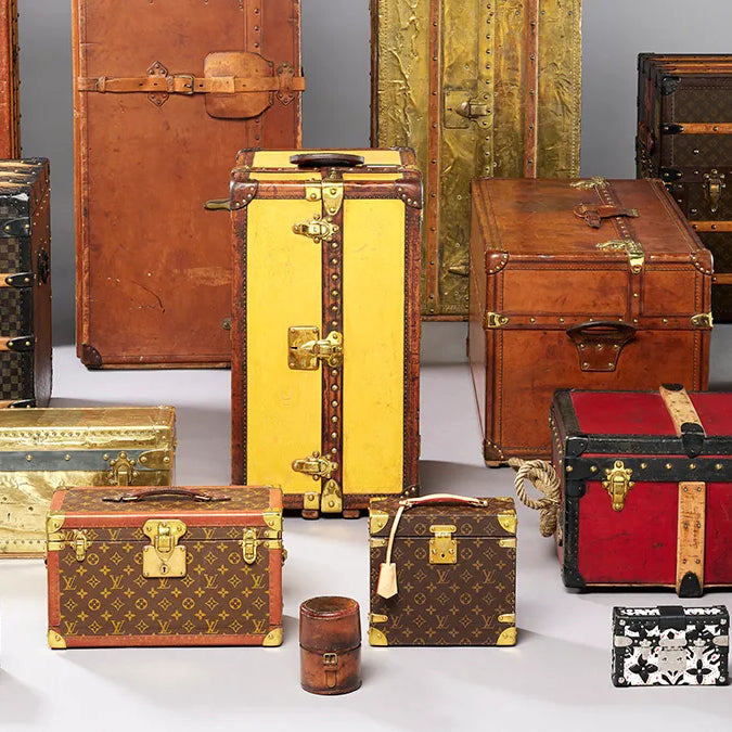 A photo of a collection of vintage Louis Vuitton Trunks