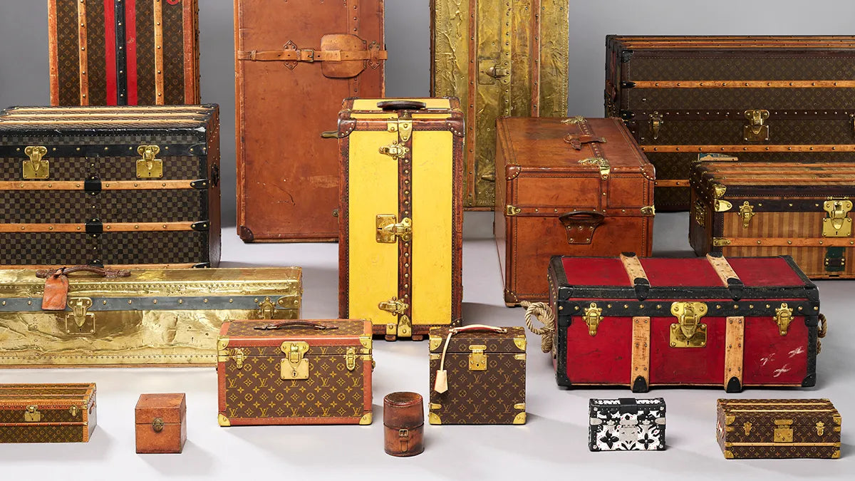 A photo of a collection of vintage Louis Vuitton Trunks