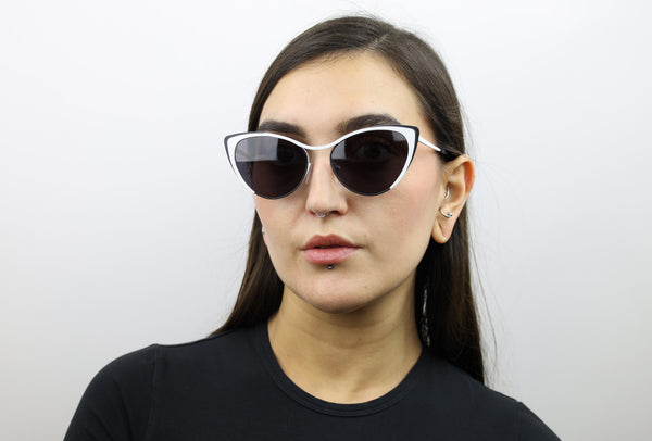 Woman wearing these luxury designer SEE cat eye sunglasses. Black glasses.