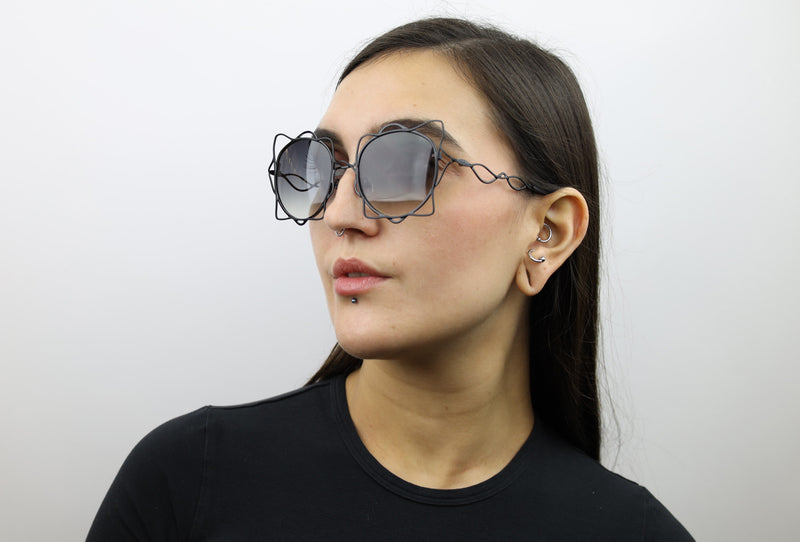 Woman wearing these luxury designer SEE sunglasses